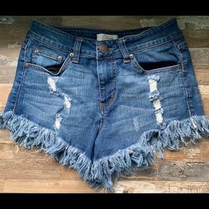 Denim shorts. Frayed bottoms.
